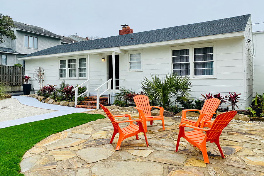cottage exterior with 4 Adirondack chairs