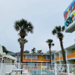 exterior of Holiday Shores with pool area and signage